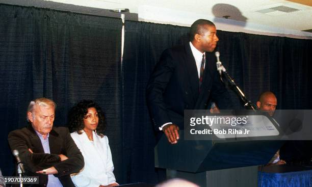 Los Angeles Lakers Owner Dr Jerry Buss , Cooke Johnson and teammate Kareem Abdul-Jabbar listen as Earvin Magic Johnson announces his retirement from...