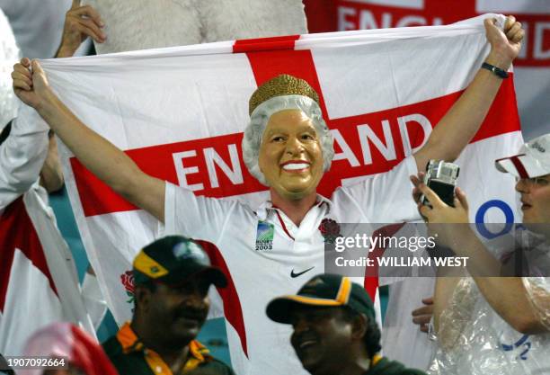 An British supporter, wearing a mask, waves the St George flag after their team won the Rugby World Cup 2003 semi-final match between France and...