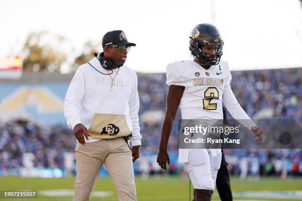 Head coach Deion Sanders and Shedeur Sanders of the Colorado Buffaloes walk together prior to a game against the UCLA Bruins at Rose Bowl Stadium on...