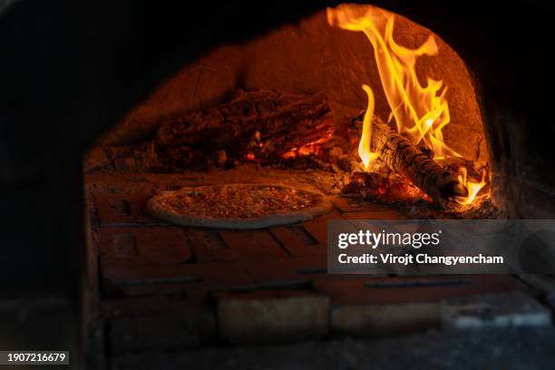 pizza baking in a charcoal oven - open fire stock pictures, royalty-free photos & images