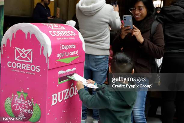 January 2 Mexico City, Mexico: Girls and boys come to the Postal Palace to write their letters for the Three Wise Men or Holy Kings prior to their...