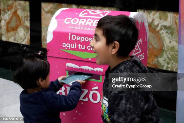 January 2 Mexico City, Mexico: Girls and boys come to the Postal Palace to write their letters for the Three Wise Men or Holy Kings prior to their...