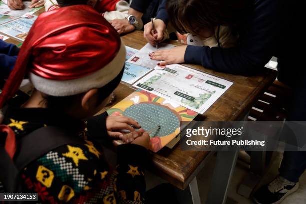 January 2 Mexico City, Mexico: Girls and boys come to the Postal Palace to write their letters for the Three Wise Men or Holy Kings prior to their...