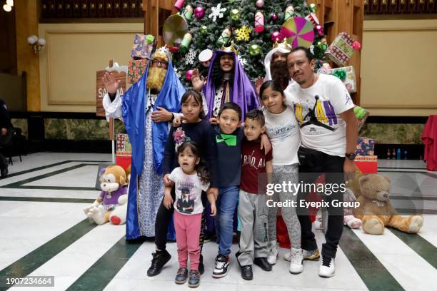 January 2 Mexico City, Mexico: The Holy Kings or Three Wise Men attend to children who come to the Postal Palace to write their letters to ask for...