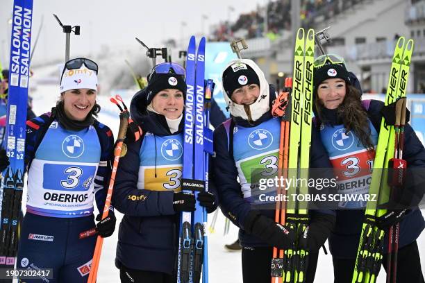 Winner France's team, France's Julia Simon, France's Sophie Chauveau, France's Justine Braisaz and France's Lou Jeanmonnot-Laurent celebrate after...