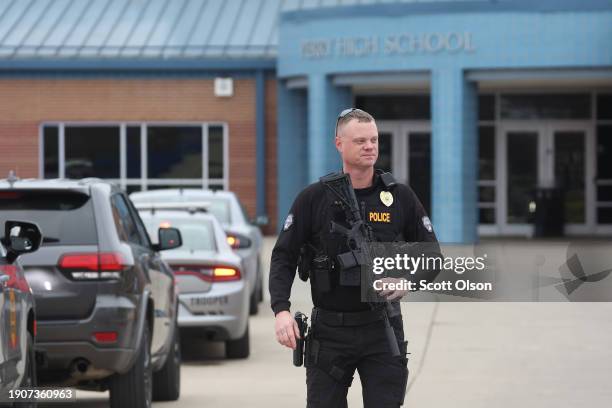 Police officer stands guard outside the Perry Middle School and High School complex following a school shooting on January 04, 2024 in Perry, Iowa....