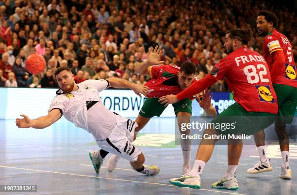 Johannes Golla of Germany is challenged by Alexandre Cavalcanti, Luis Frade and Gilberto Duarte of Portugal during the Men's International Friendly...