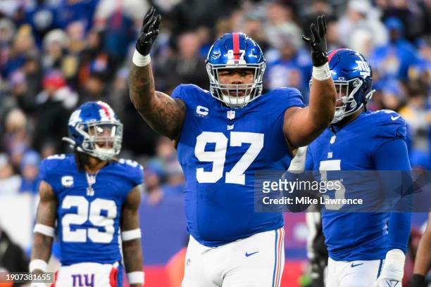 Dexter Lawrence II of the New York Giants hypes up the crowd during a game against the Los Angeles Rams at MetLife Stadium on December 31, 2023 in...