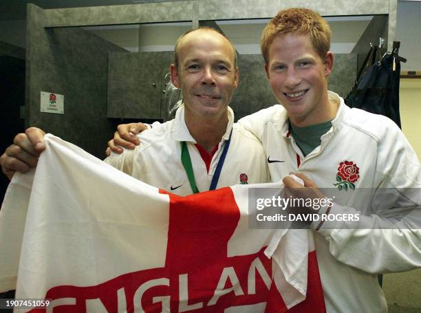 English coach Clive Woodward celebrates with Prince Harry in the dressing room after England's win in the Rugby World Cup final between Australia and...