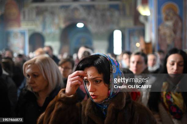 Members of the congregation pray during a service of the Nativity of Christ Liturgy at the Serbian Orthodox Church of the Holy Prince Lazar in...