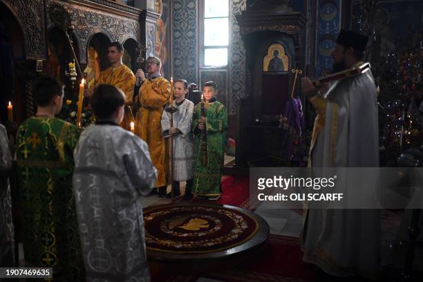 Members of the clergy hold a service of the Nativity of Christ Liturgy at the Serbian Orthodox Church of the Holy Prince Lazar in Bournville,...