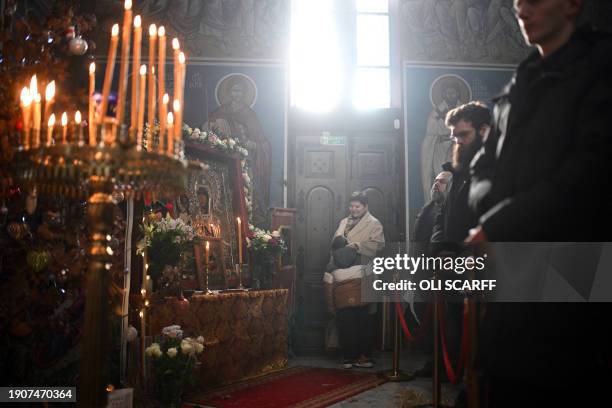 Members of the congregation listen during a service of the Nativity of Christ Liturgy at the Serbian Orthodox Church of the Holy Prince Lazar in...