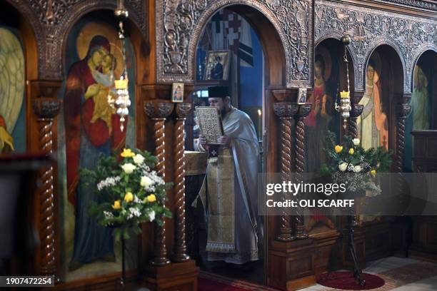 Serbian Orthodox Christian priest, Father Nenad Popovic leads a service of the Nativity of Christ Liturgy at the Serbian Orthodox Church of the Holy...