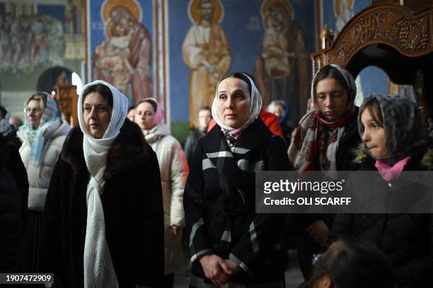 Members of the congregation listen during a service of the Nativity of Christ Liturgy at the Serbian Orthodox Church of the Holy Prince Lazar in...