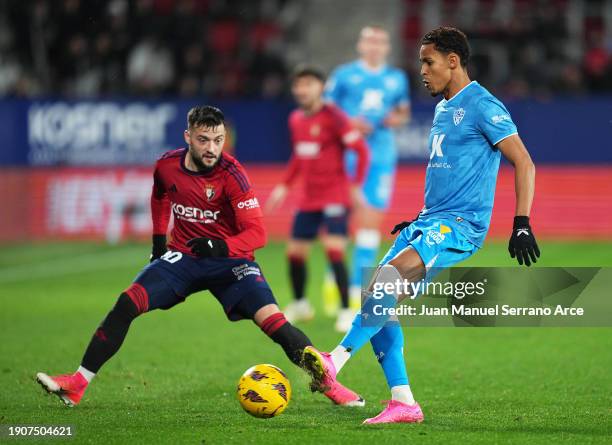 Lazaro of UD Almeria passes the ball whilst under pressure from Jose Arnaiz of CA Osasuna during the LaLiga EA Sports match between CA Osasuna and UD...