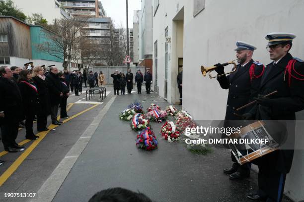 Musicians of the police perform as Former French president Francois Hollande, Paris Mayor Anne Hidalgo, French National Assembly President Yael...