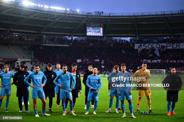 Napoli's players react on the pitch at the end of the Italian Serie A football match Torino vs Napoli at the "Stadio Grande Torino" in Turin on...