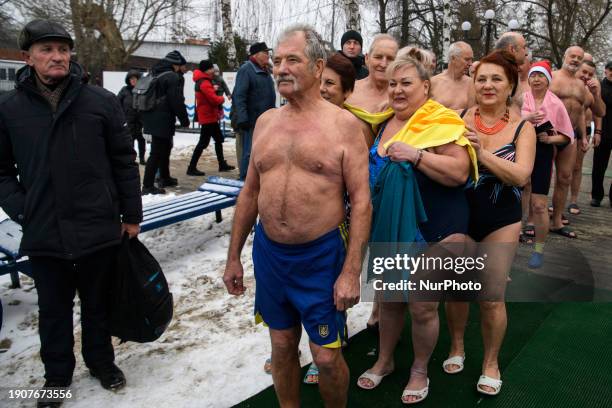Orthodox believers are standing on the bank of the Dnipro River following the Orthodox Christian feast of Epiphany service led by Metropolitan...