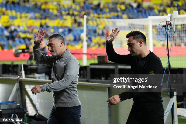 Garcia Pimienta, Head Coach of UD Las Palmas, and Xavi, Head Coach of FC Barcelona, acknowledge the fans prior to the LaLiga EA Sports match between...