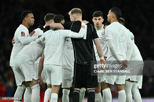 Arsenal players wearing their all-white kit to support their "No More Red" anti-knife crime campaign have a pre-game huddle during the English FA Cup...