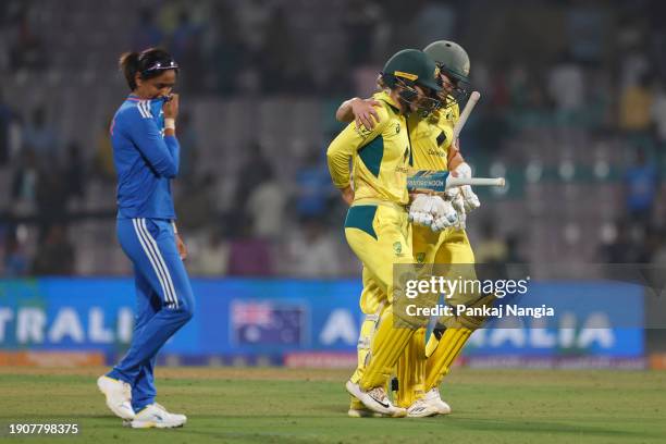 Ellyse Perry and Phoebe Litchfield of Australia celebrate their team's win over India during game two of the women's T20I series between India and...