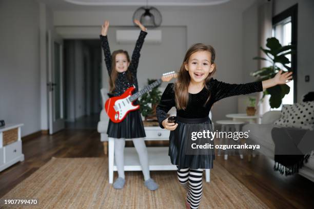 cute girls playing guitar and singing - gig living room stock pictures, royalty-free photos & images