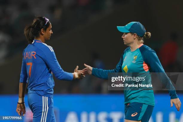 Harmanpreet Kaur of India and Alyssa Healy of Australia shake hands after the match two of the women's T20I series between India and Australia at DY...