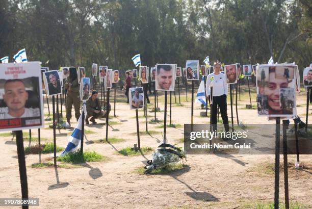 Photos of people killed or kidnapped during the Hamas attack on the Super Nova festival on October 7th are displayed in a temporary memorial site on...