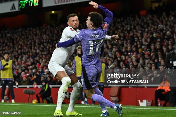 Arsenal's English defender Ben White clashes with Liverpool's English midfielder Curtis Jones during the English FA Cup third round football match...