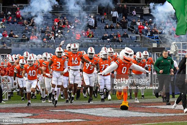 Miami's team, led by mascot Sebastian the Ibis and head coach Mario Cristobal, takes the field immediately prior to the game as the Miami Hurricanes...