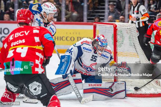 Jason Fuchs of Lausanne HC tries to score against Goalie Juha Metsola of EHC Kloten during the National League match between Lausanne HC and EHC...