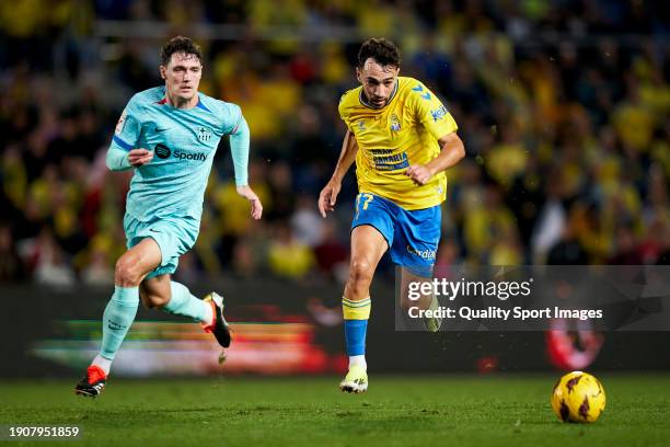 Munir El Haddadi of UD Las Palmas runs with the ball under pressure from Andreas Christensen of FC Barcelona during the LaLiga EA Sports match...