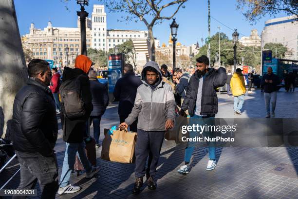 Tourists are taking advantage of their vacation and shopping in the city center on the first day of winter sales in Barcelona, Spain, on January 7,...