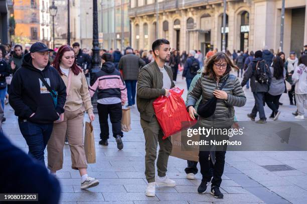 Group of people are carrying shopping bags at Portal del Angel on the first day of winter sales in Barcelona, Spain, on January 7, 2024. Portal del...