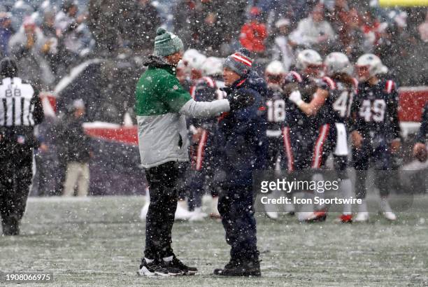 New York Jets quarterback Aaron Rodgers speaks with New England Patriots head coach Bill Belichick before a game between the New England Patriots and...