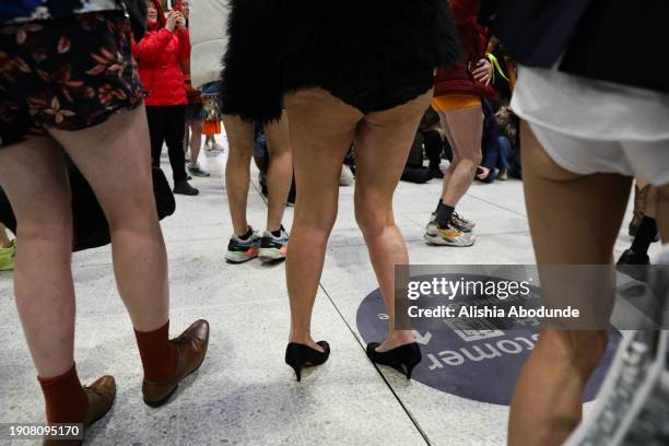 Passengers without trousers prepare to travel on a London Underground train as part of the 'No Trousers Tube Ride' event on January 7, 2024 in...