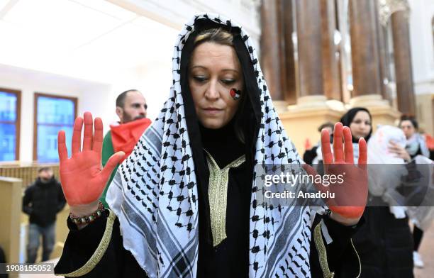 Women holding bloody dolls in their hands gather in historical Stock Exchange building to protest against Israeli attacks over Gaza and to show their...