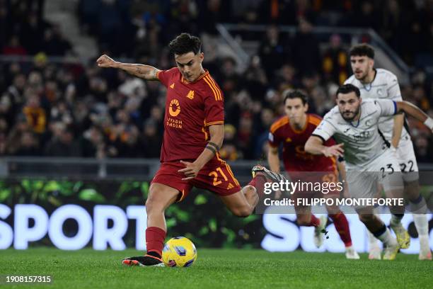 Roma's Argentine forward Paulo Dybala kicks a penalty to score Roma's first goal during the Italian Serie A football match between AS Roma and...