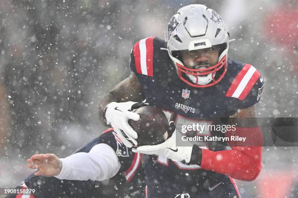 Ezekiel Elliott of the New England Patriots runs with the football during the second half against the New York Jets at Gillette Stadium on January 7,...