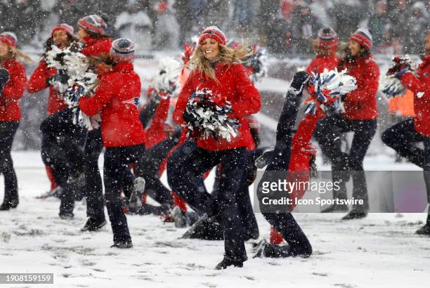Patriots cheerleaders dance in the snow during a game between the New England Patriots and the New York Jets on January 7 at Gillette Stadium in...