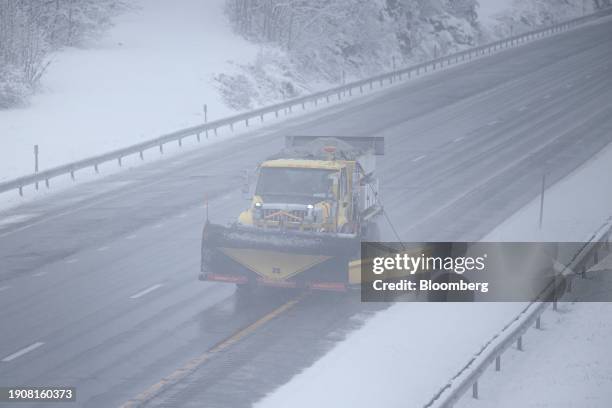 Snow plow truck operates on I-87 during a storm in Leeds, New York, US, on Sunday, Jan. 7, 2024. Hundreds of flights have been grounded across the US...