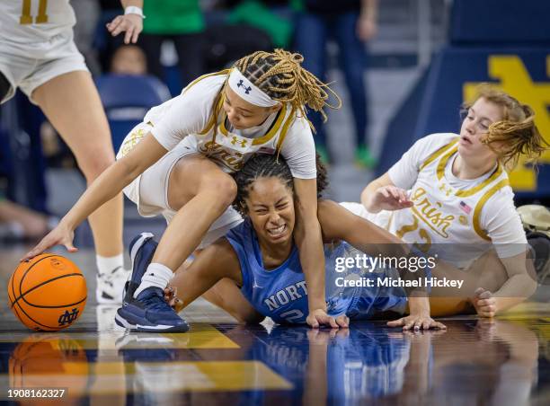 Hannah Hidalgo of the Notre Dame Fighting Irish fights for the loose ball against Indya Nivar of the North Carolina Tar Heels during the second half...