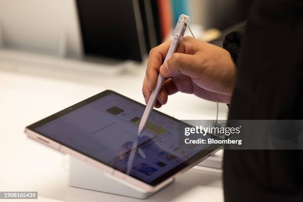 Customer tries out a Samsung Electronics Co. Galaxy Tab S9 Ultra tablet device at the Samsung Store in Seoul, South Korea, on Sunday, Jan. 7, 2024....