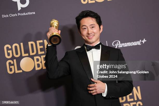 Steven Yeun poses with the award for Best Performance by a Male Actor in a Limited Series, Anthology Series, or a Motion Picture Made for Television...