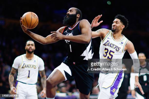Clippers guard James Harden drives to the basket past Los Angeles Lakers forward Christian Wood during the first half at Crypto.com Arena in Los...