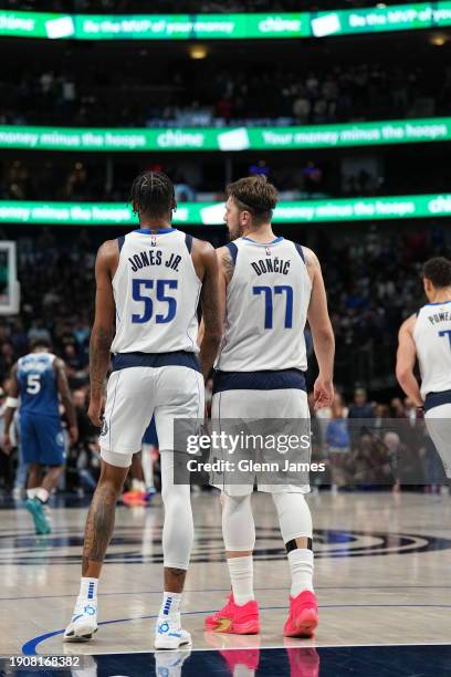 Derrick Jones Jr. #55 of the Dallas Mavericks and Luka Doncic of the Dallas Mavericks look on during the game against the Minnesota Timberwolves on...