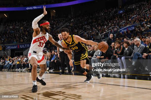 Stephen Curry of the Golden State Warriors dribbles the ball during the game against the Toronto Raptors on January 7, 2024 at Chase Center in San...