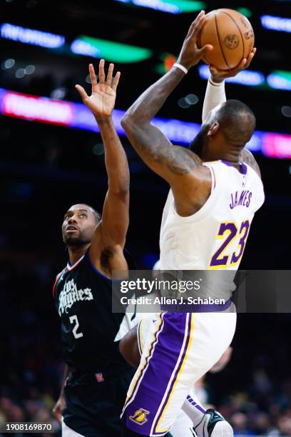 Clippers forward Kawhi Leonard defends a shot by Los Angeles Lakers forward LeBron James during the second half at Crypto.com Arena in Los Angeles...