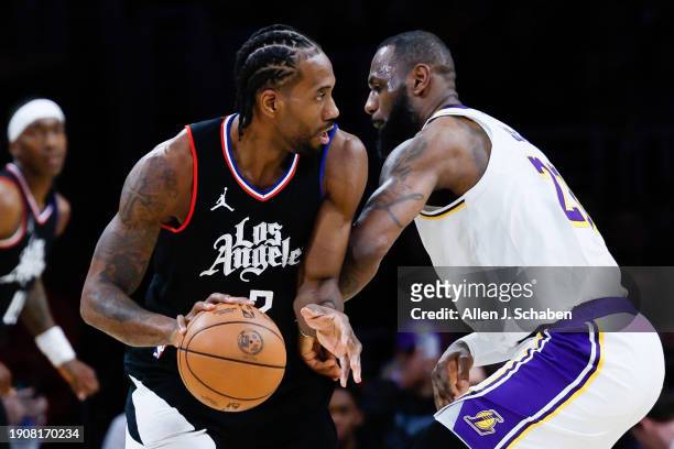 Clippers forward Kawhi Leonard handles the ball while Los Angeles Lakers forward LeBron James defends during the second half at Crypto.com Arena in...
