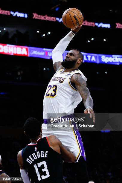 Los Angeles Lakers forward LeBron James rises up for a dunk while LA Clippers forward Paul George defends during the second half at Crypto.com Arena...